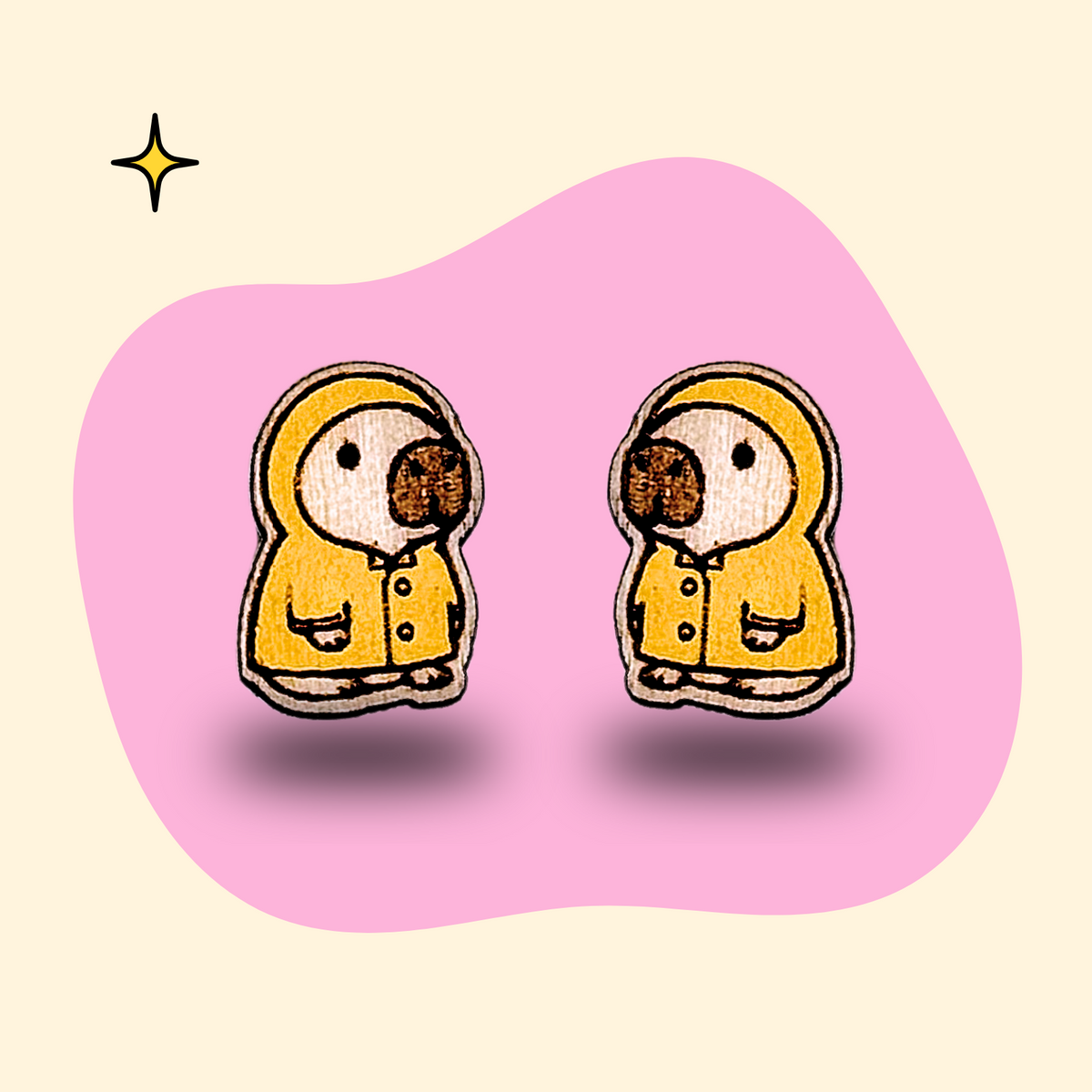 Hand-painted wooden capybara ear studs in raincoats by GRAINN