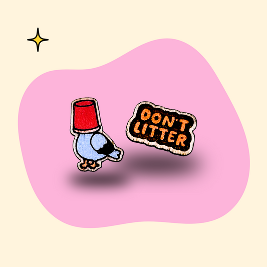 Mismatched hand-painted wooden ear studs, a pigeon with a cup on its head and a Don't Litter sign, by GRAINN